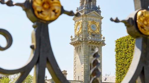 View of the Italianate clock tower through ornate gates at Cliveden, Buckinghamshire